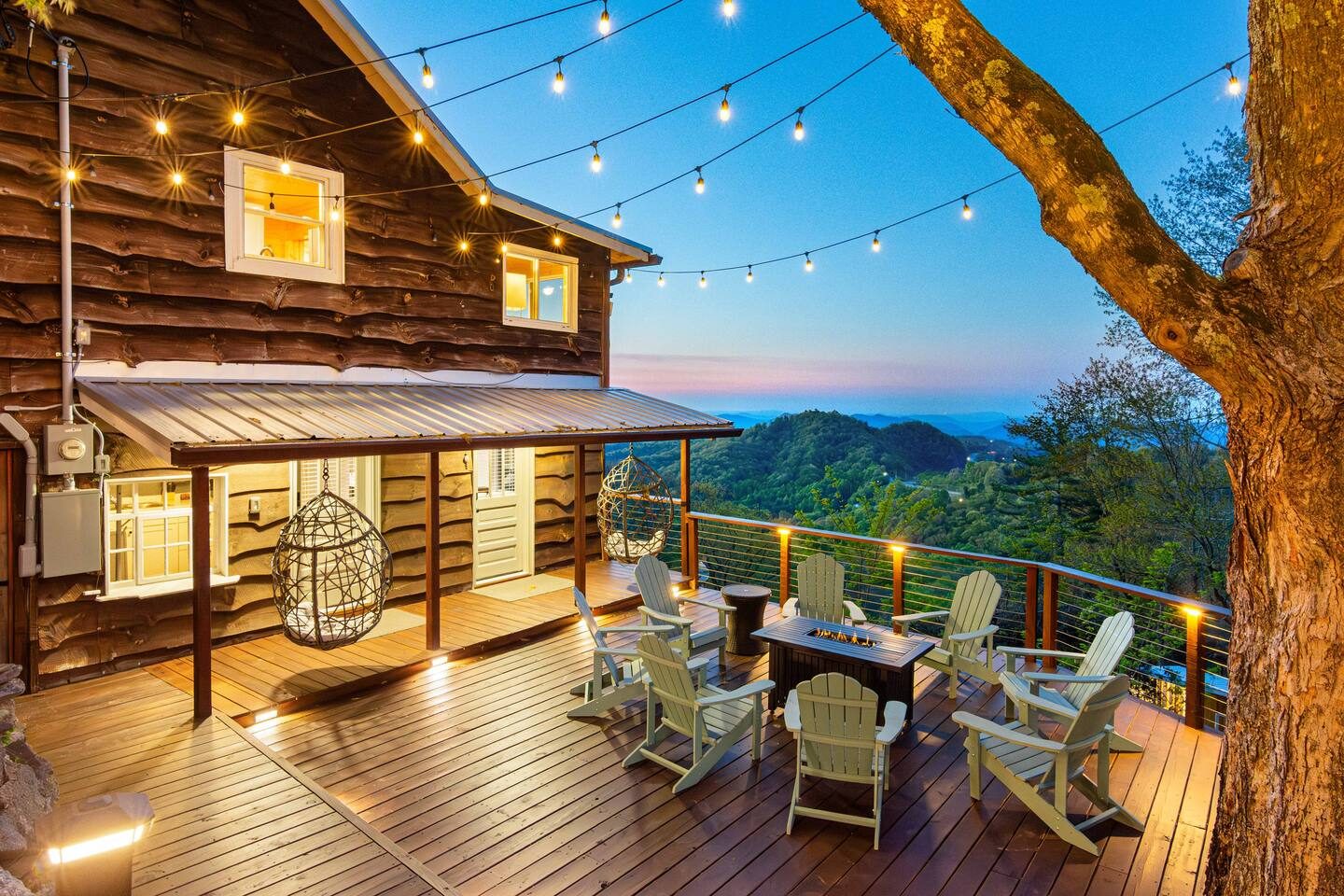 Log cabin deck with string lights and mountain view